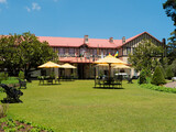 Fototapeta Tęcza - Nuwara Eliya, Sri Lanka - March 10, 2022: View of the Grand Hotel built in the colonial style. The hotel is beautifully landscaped