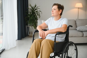 Wall Mural - middle aged woman sitting on wheelchair