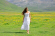 © Antonioguillem - Woman with white dress walking in a field in the mountain