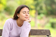 © PheelingsMedia - Teen relaxing and resting on a bench in a park