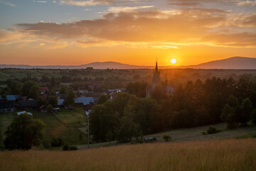 Wall Mural - Beautiful sunset over a mountain village in Poland