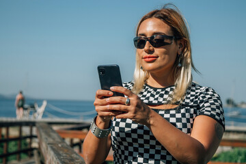 Wall Mural - beautiful smiling young curvy body positive woman using smartphone