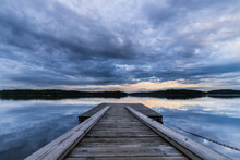 Sweden, Vastra Gotaland County, Cloudy Sky Over Jetty On Shore Of Vastra Silen Lake At Dusk
