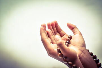 Wall Mural - Muslim child man lift two hand for praying and wearing bead on hand to determine the number of prayer services,isolated on white background.concept for Ramadan, Eid al Fitr, eid ad-ha, meditation