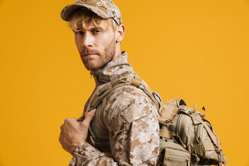 Wall Mural - White military man wearing uniform posing and looking at camera