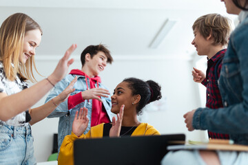 Wall Mural - high school students meeting and greeting in classroom after school holidays, back to school concept