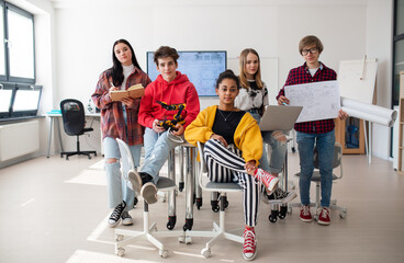 Sticker - Group of students sitting and posing together in robotics classroom