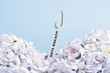 Word Data breach hooked on fishing hook pulled from pile of shredded documents on blue background