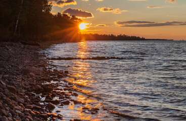 Wall Mural - dawn landscape of baikal lake. view of the rising sun over the small sea strait in the early summer 