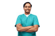 © Syda Productions - healthcare, profession and medicine concept - happy smiling indian doctor or male nurse in blue uniform with crossed arms over white background