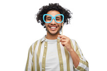 Party Props, Photo Booth And People Concept - Happy Smiling Young Man With Paper Glasses Over White Background