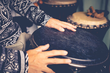 djembe, peoples hand playing music at djembe drums,african drums