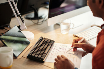Wall Mural - front end developer drawing wireframe of website at office desk