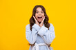 Shocked teenager child with amazed look on yellow background, amazement. Amazed teen girl. Excited expression, cheerful and glad.