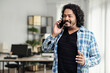 © DragonImages - Portrait of smiling excited startup founder talking on phone with investor
