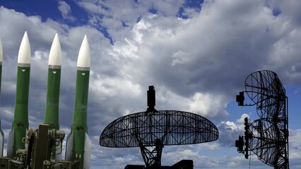 Wall Mural - Air defense radars of military mobile anti aircraft systems and Russian anti aircraft missiles OSA-AKM on background clouds (time lapse, with zoom),Russia