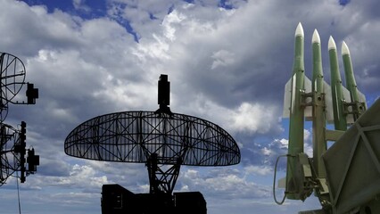 Wall Mural - Air defense radars of military mobile anti aircraft systems and Russian anti aircraft missiles OSA-AKM on background clouds (time lapse, with zoom),Russia