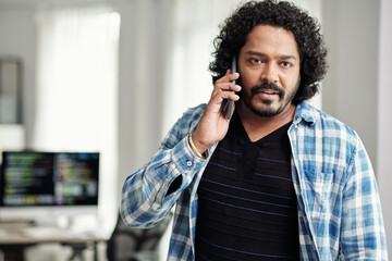 Wall Mural - portrait of indian startup founder talking on phone when leaving office