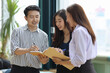 © feeling lucky - Collaborative process of young asian business people team working together discussing, researching, brainstorming and planning work at business meeting in modern office building and city background