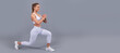 © Olena - happy girl in sportswear do squat lunge. fit your body. warming up before training. Woman isolated face portrait, banner with mock up copyspace.