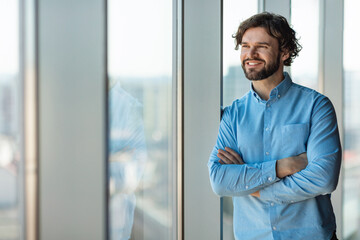 Wall Mural - Portrait of confident mature businessman standing near window in modern company office, copy space