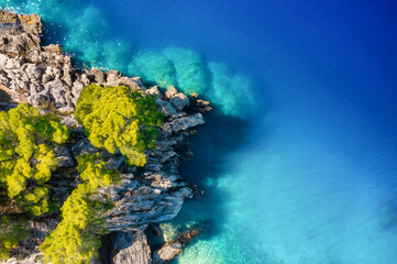 Croatia. Aerial view on rocks and forest. Vacation and adventure. Rocks and turquoise water. Top view from drone at beach and blue sea. Landscape from air. Travel image.