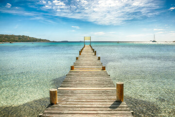 Wall Mural - Astonishing landscape with wooden pier on Santa Giulia beach.