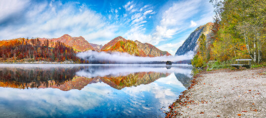 Wall Mural - outstanding autumn scene of foggy and sunny morning on almsee lake