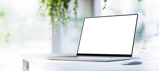 Wall Mural - laptop with blank screen on table panorama in bright office