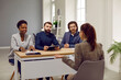 © Studio Romantic - Employment and hiring. Friendly group of HR employees during interview in office talk to woman with job applicant. Three multiracial female and male colleagues are sitting at table in front of woman.