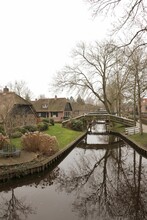 Vertical Shot Of Picturesque Houses And Small Bridges In Giethoorn, The Netherlands