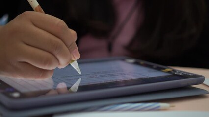 Wall Mural - businesswoman writing stylus pen note on digital tablet computer for e-learning education online lea