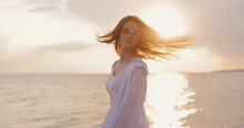 Young Sexy Woman Tossing Hair At The Sea Sunset Turning Face