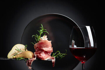 Wall Mural - Red wine with prosciutto, pears and rosemary.