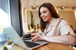 © fotofabrika - Young businesswoman using a laptop during a coffee break in coffeeshop