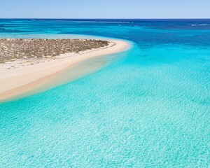 Idyllic seascape with clear blue water and white sand beach