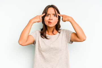 Wall Mural - Young hispanic woman isolated on blue background praying, showing devotion, religious person looking for divine inspiration.