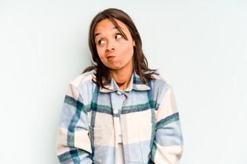 Canvas Print - Young hispanic woman isolated on blue background makes scale with arms, feels happy and confident.