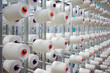 Textile industry - spools of yarn on spinning machine in a textile factory