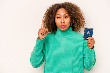 Young African American informatic woman isolated on white background showing number one with finger.