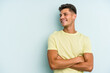 © Asier - Young caucasian man isolated on blue background smiling confident with crossed arms.