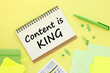 © Svetlana - CONTENT IS KING yellow background with text on an open notepad ,business analysis and strategy as concept