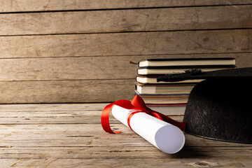 Poster - Image of stack of books and diploma on wooden surface