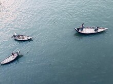 Aerial View Of Boats Floating On A Blue Lake Surface