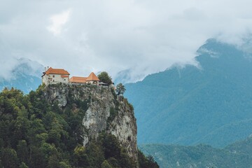 Sticker - View of the Bled Castle on the cliff against the green hills. Slovenia.