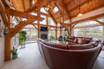 Sticker - Cozy living room interior with a couch, plants, large windows, and a fireplace