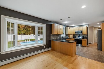 Sticker - Interior view of the modern kitchen made of wood with a pool outside