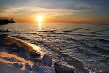 Scene Of Orange Sunrise On Lake Huron Waves During Summer