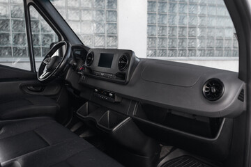 Poster - Luxury van driver seats with dashboard, multimedia control screen, and steering wheel. The cockpit of a modern luxury minivan