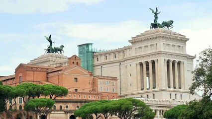 Wall Mural - View of the Roman Forum in Rome, Italy. Ancient excavations with Victor Emmanuel II Monument on the background, walking people